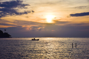 sunset on sea with boat