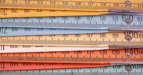 Old wooden folding meter ruler measuring centimeters