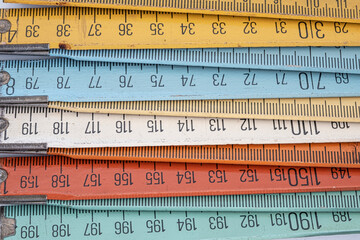 Old wooden folding meter ruler measuring centimeters