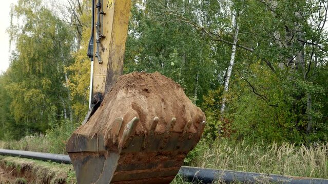 digging ground by excavator on construction site, process of gasification and building