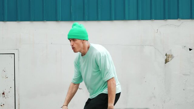 Closeup of youthful hipster moving in lively groove at street. Caucasian break dance choreographer dancing in hip hop style. Energetic dancer perform b-boy dance. Outdoor sport 2024. hiphop.