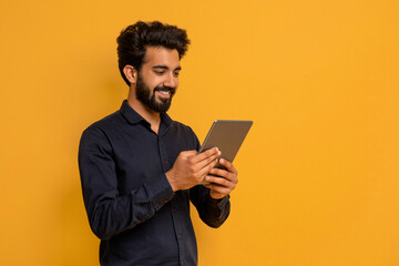 Great App. Smiling Young Indian Man Using Digital Tablet