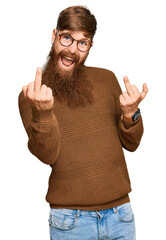 Young irish redhead man wearing casual clothes and glasses showing middle finger doing fuck you bad...