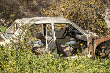 A dilapidated vehicle abandoned with a criminal against the environment