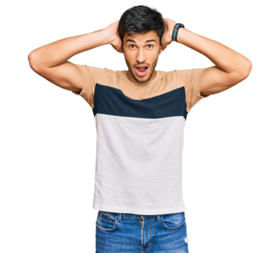 Young handsome man wearing casual clothes crazy and scared with hands on head, afraid and surprised of shock with open mouth