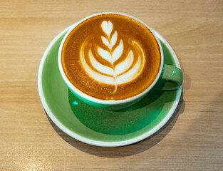 Artful Brew: Hot Coffee Latte Art in a Green Mug