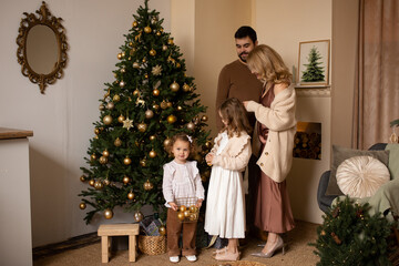 happy family in their living room, in front of the Christmas tree