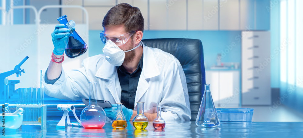 Poster man chemist. laboratory assistant sits at table with flasks. chemist holds test tube with reagents. 