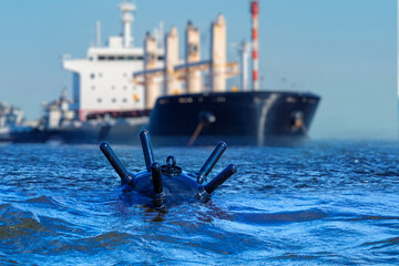 Anti-ship mine in water. Sea tanker floats near bomb. Ship mine to protect sea borders. Underwater...