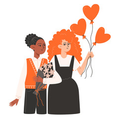 Two women stand side by side and hold red balloons in the shape of a heart for Valentine's Day