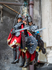 Marionettes of Sicily: Knights in armor, sword and shield in streey market, Italy