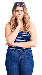 Young caucasian woman wearing casual clothes and sunglasses thinking looking tired and bored with depression problems with crossed arms.