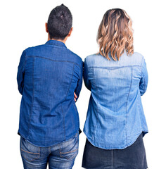 Couple of women wearing casual clothes standing backwards looking away with crossed arms