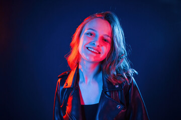 Positive facial expression. Cool young woman portrait in neon colors