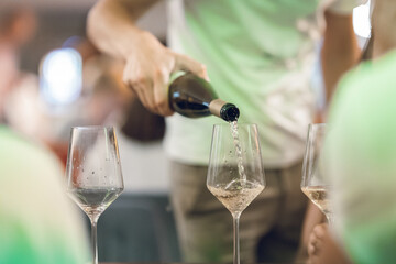 Man is Pouring Wine into Glasses