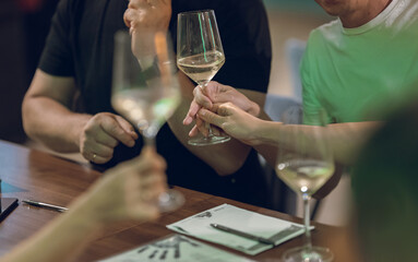 People Enjoying Wine and Conversation at a Table