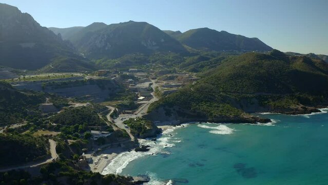 Aerial drone view of Porto Flavia, Masua and Porto Cauli beaches and mines on the background in Sardinia, Italy
