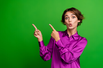 Photo of adorable cute lady wear purple stylish clothes presenting billboard news empty space isolated on green color background