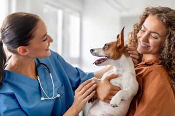 Two women and a dog at vet visit
