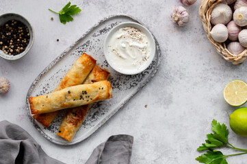 Turkish Cigara Börek (Sigara böreği) or Cigarette Pastry with Spinach and Feta Cheese with...