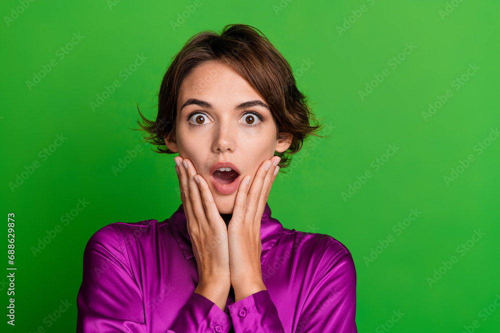 Sticker Photo of terrified impressed lady open mouth hands touch face cheeks unexpected information empty space isolated on green color background