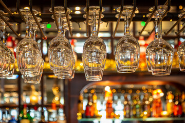 Wine glasses hanging over a bar, with a shallow depth of field