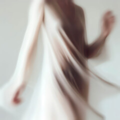 Dancing women in white dresses. The photo is motion blurred.