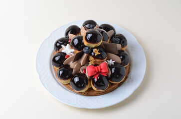 Profiterole Cake, St. Honore Cake with Christmas Decorations on Bright Background