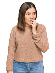 Young beautiful woman wearing casual clothes looking stressed and nervous with hands on mouth biting nails. anxiety problem.