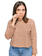 Young beautiful woman wearing casual clothes mouth and lips shut as zip with fingers. secret and...