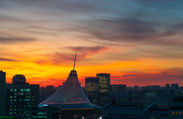 Astana, Kazakhstan, November 2023. View of the Khan-Shatyr shopping center against the backdrop of sunset.