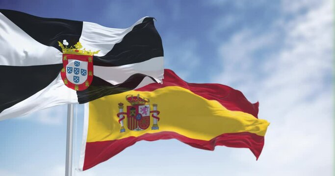 Ceuta and spanish national flags waving on a clear day