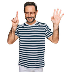 Middle age man wearing casual clothes and glasses showing and pointing up with fingers number six while smiling confident and happy.