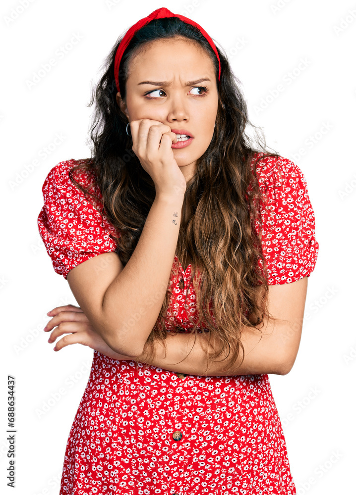 Sticker Young hispanic girl wearing casual clothes looking stressed and nervous with hands on mouth biting nails. anxiety problem.