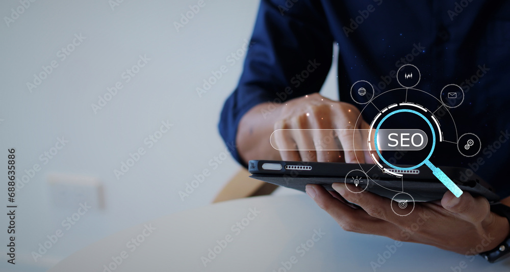 Poster seo concept. a businessman's hand holds the ipad and presses the button with an seo icon for optimiz