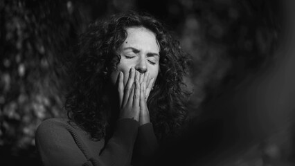 Distressed woman covering face in shame during difficult times, preoccupied fearful 20s person...