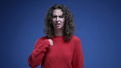 Baffled woman reacting to accusation with surprise, pointing finger to herself rejecting...