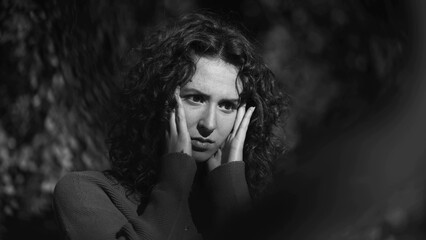 Distressed woman covering face in shame during difficult times, preoccupied fearful 20s person...