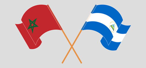Crossed and waving flags of Morocco and Nicaragua