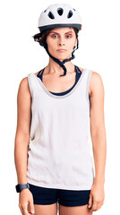 Beautiful young woman with short hair wearing bike helmet with serious expression on face. simple and natural looking at the camera.