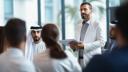 A Dubai businessman gives a clever presentation to a business partner team
