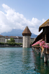 View of the Chapel Bridge and the Wasserturm (water tower) on river Reuss in historic city of...