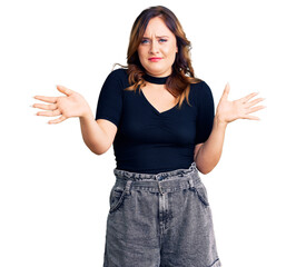 Young beautiful caucasian woman wearing casual clothes clueless and confused expression with arms...