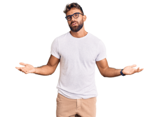 Young hispanic man wearing casual clothes and glasses clueless and confused with open arms, no idea concept.