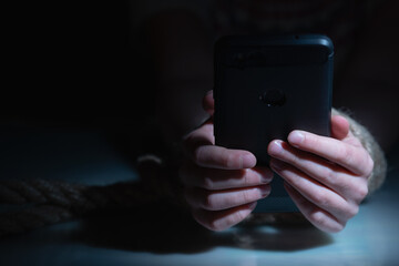 Top view of young child girl playing smartphones during night time. She is chatting with her friend. Using phone in low light is impact to eyes. 
