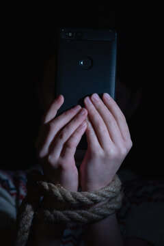 Young child girl playing smartphones during night time. She is chatting with her friend. Using phone in low light is impact to eyes. Health and gadget addiction concept. Vertical image.