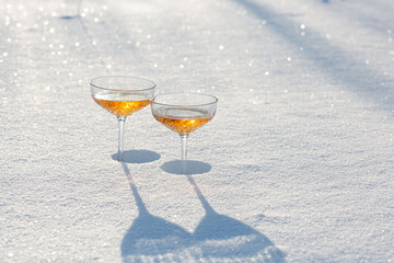 Two glasses of champagne in the snow