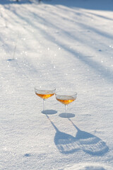Two glasses of champagne in the snow