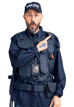 Young handsome man wearing police uniform surprised pointing with finger to the side, open mouth amazed expression.