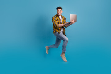 Full length photo of man just learned new code language future programmer running to employers with laptop isolated on blue color background